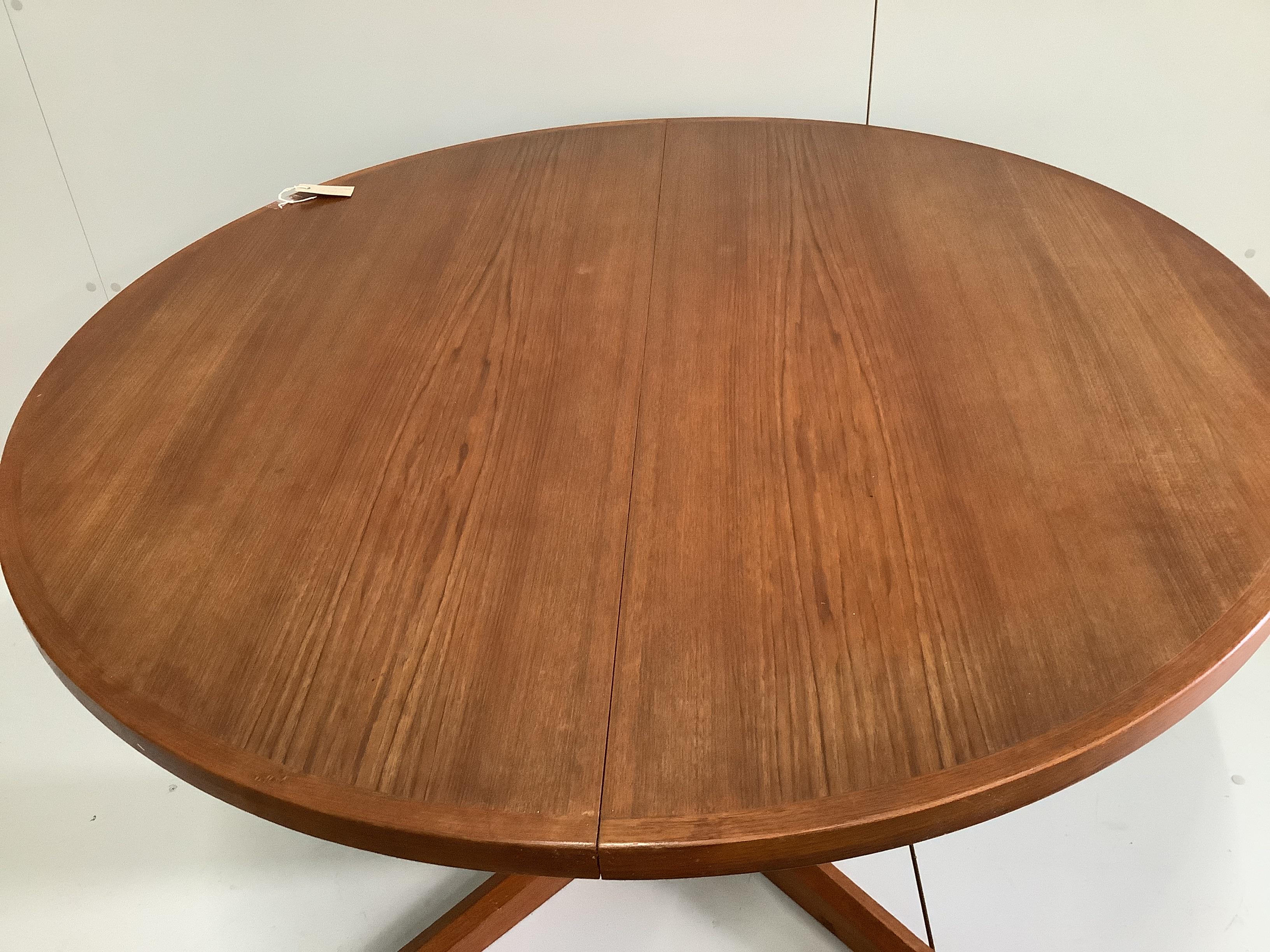 A Gudme Mobelfabrik mid century teak extending dining table, 220cm extended, two spare leaves, depth 122cm, height 73cm and four chairs